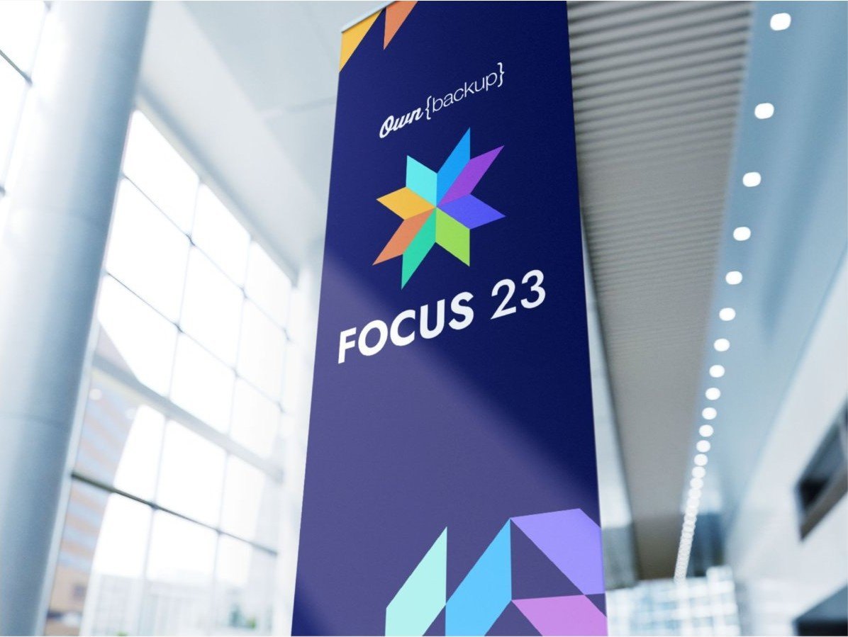 Tall FOCUS 23 banner hanging in an atrium